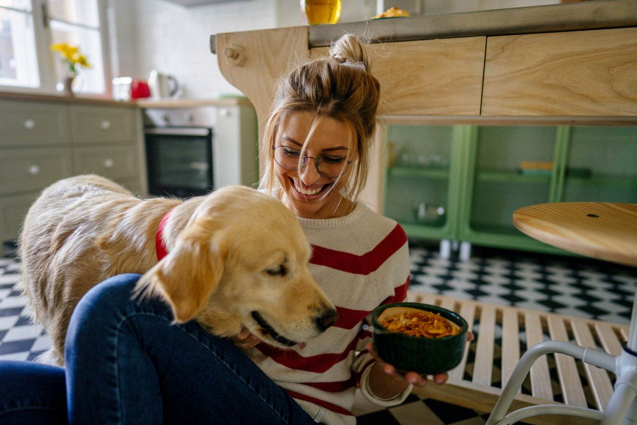 Woman feeding her dog